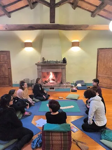 Il cerchio di pratica sui tappetini davanti al camino, sotto le travi di legno